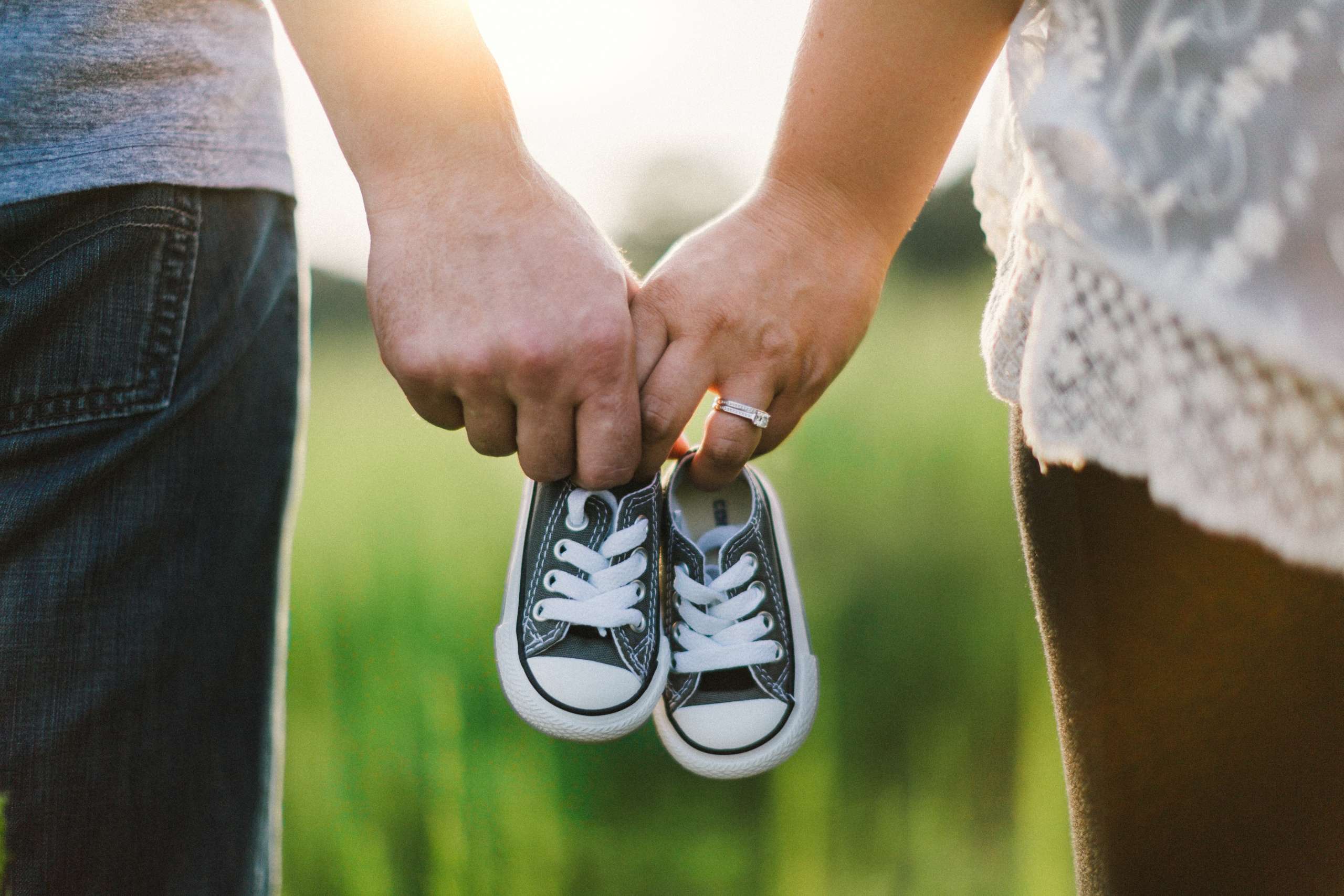 adoptive parents holding shoes